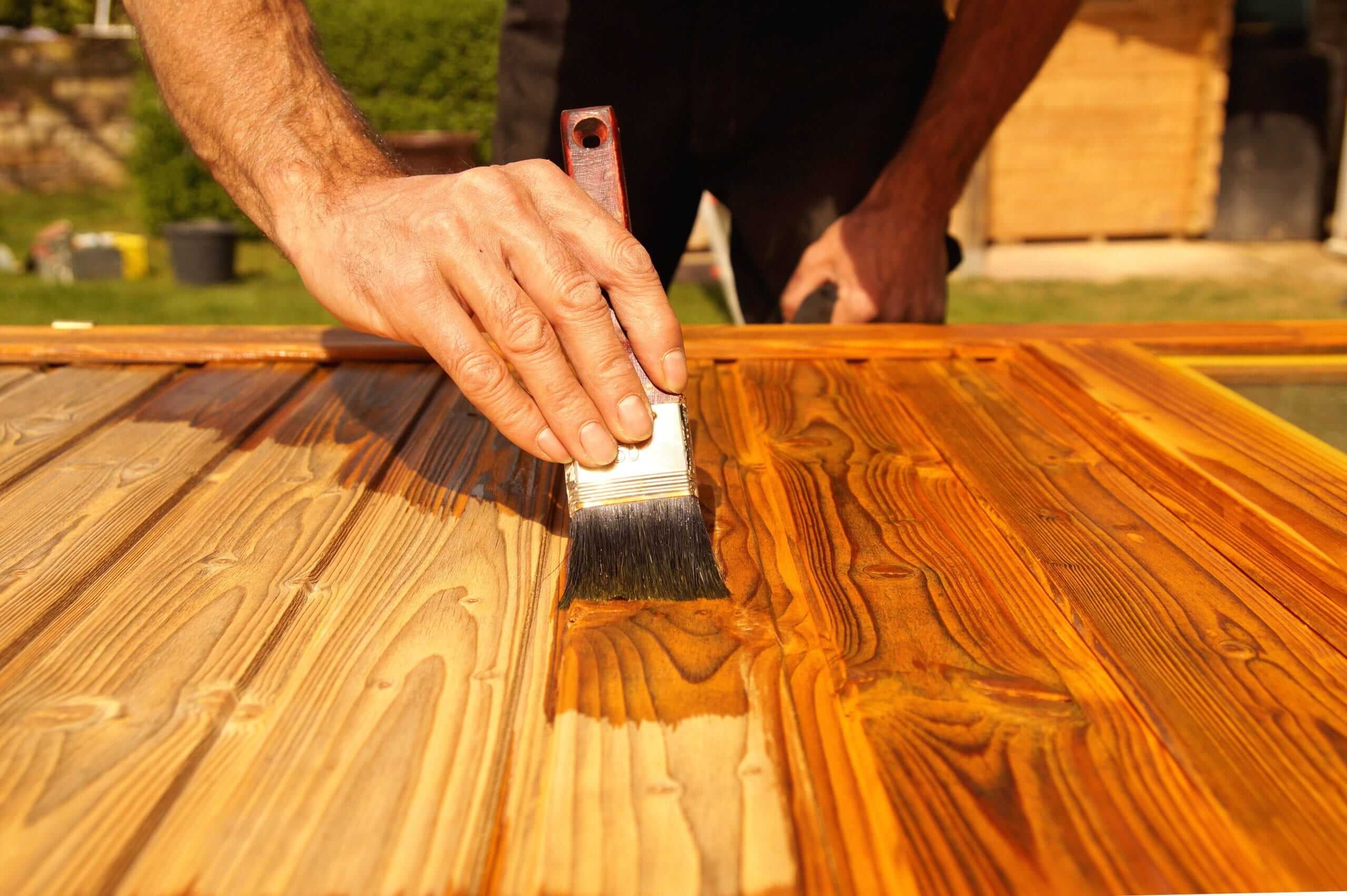 Painting,Woodwork,Outside,In,Spring.,Close-up,Of,Male,Hand,Varnishes