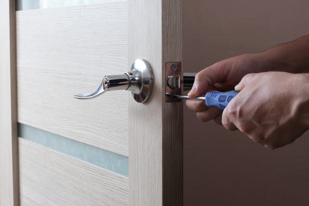 Man repairing commercial door