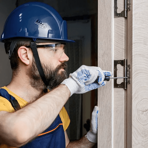 man repairing commercial door frame