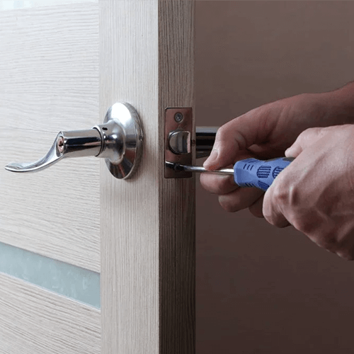 Man repairing commercial door